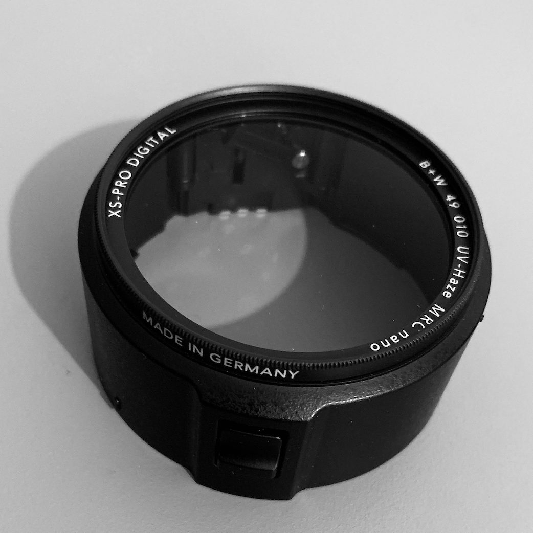 Ricoh Ga-1 lens adapter with a B+W UV filter. Portrayed in black and white.